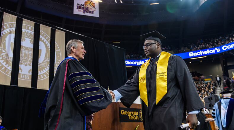 Former Georgia Tech offensive lineman Shamire Devine accepts congratulations from school president G.P. "Bud" Peterson at the school's commencement exercises last Saturday.