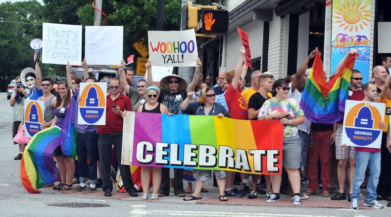 JUNE 26, 2013 ATLANTA Rally participants stood on all four four corners of the intersection. A rally of gay rights supporters cheers the Supreme Court ruling on gay marriage at the corner of Piedmont Ave and 10th Street in Midtown Atlanta Wednesday, June 26, 2013. KENT D. JOHNSON/KDJOHNSON@AJC.COM