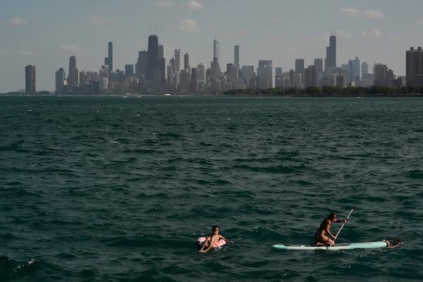 People cool off in a Lake Michigan shore Sunday, June 22, 2025, in Chicago. (AP Photo/Kiichiro Sato)