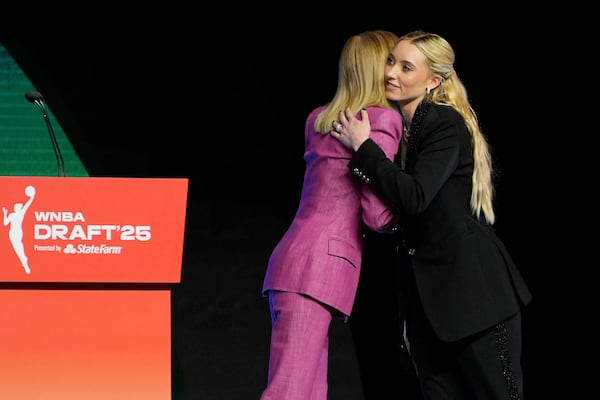 UConn's Paige Bueckers, right, embraces WNBA commissioner Cathy Engelbert after being selected first overall by the Dallas Wings during the first round of the WNBA basketball draft, Monday, April 14, 2025, in New York. (AP Photo/Pamela Smith)
