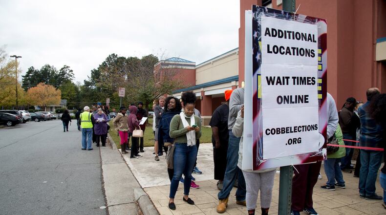People wait in a long line to vote at the Cobb County Board of Elections and Registration office in Marietta Saturday, Oct. 27, 2018. STEVE SCHAEFER / SPECIAL TO THE AJC