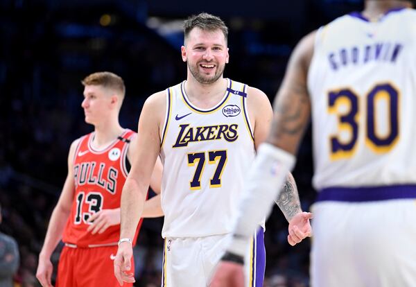 Los Angeles Lakers guard Luka Doncic (77) smiles after making a basket against the Chicago Bulls of an NBA basketball game Saturday, March 22, 2025, in Los Angeles. (AP Photo/Wally Skalij)