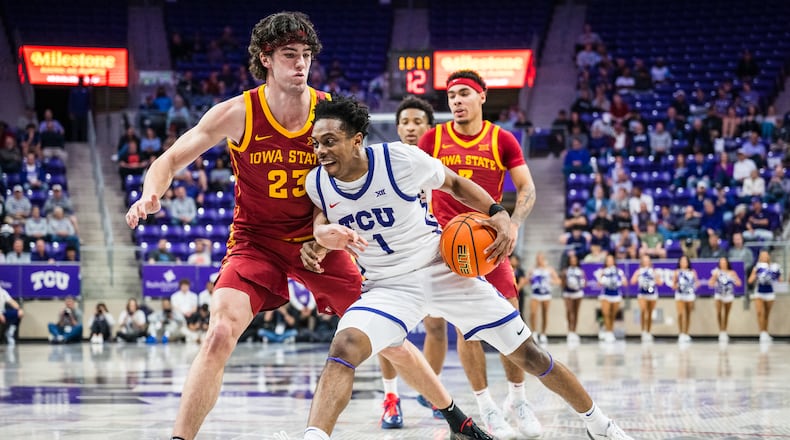 TCU guard Jayden Pierre (1) drives the ball against Iowa State forward Blake Buchanan (23) during an NCAA college basketball game, Tuesday, Feb. 10, 2026, Fort Worth, Texas. (AP Photo/Jessica Tobias)