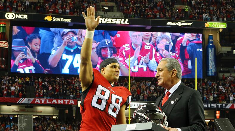 122913 ATLANTA: Falcons tight end Tony Gonzalez waves to fans as team owner Arthur Blank presents him a helmet during a half time ceremony honoring his 17 year NFL football career on Sunday, Dec. 29, 2013, in Atlanta.   CURTIS COMPTON / CCOMPTON@AJC.COM