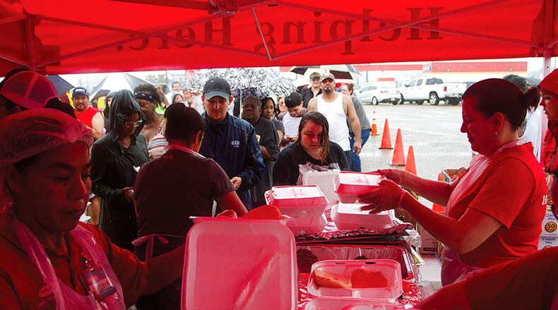 H-E-B Grocery Stores set up a Mobile Kitchen in the parking lot of their location in Victoria, Texas to help provide free hot meals to those affected by Hurricane Harvey on Sunday, Aug. 27, 2017. (Nicolas Galindo/The Victoria Advocate via AP)