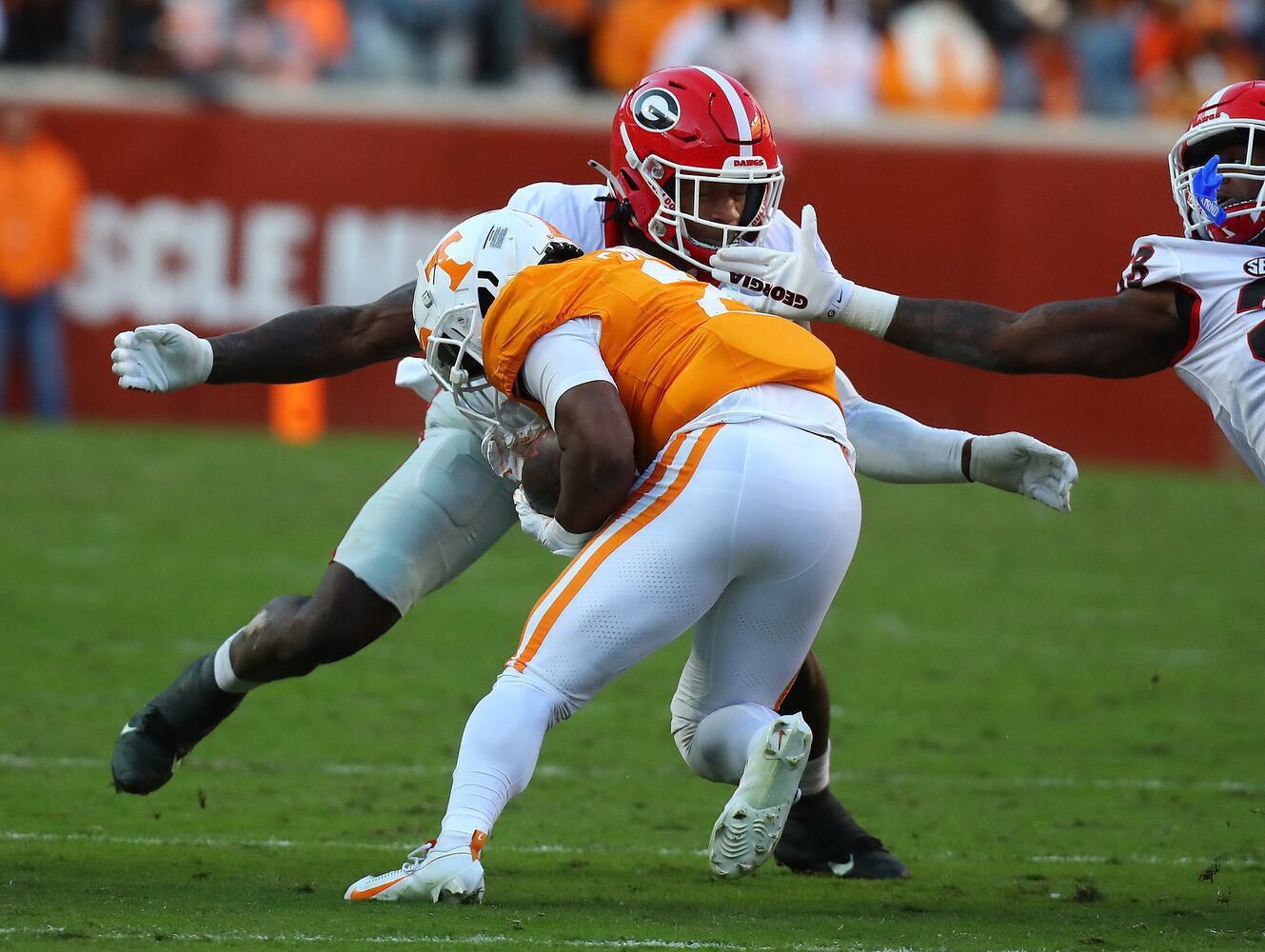 Georgia linebacker Smael Mondon Jr. tackles Tennessee running back Jabari Small during the first half in a NCAA college football game on Saturday, Nov. 18, 2023, in Knoxville.  Curtis Compton for the Atlanta Journal Constitution