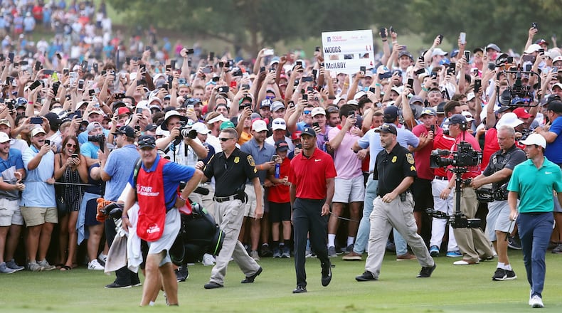 Tiger Woods is in there, somewhere, walking to the 18th green during the final round of last year's Tour Championship at East Lake. (Photo by Tim Bradbury/Getty Images)