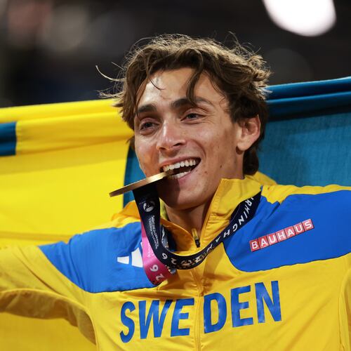 Sweden's Armand Duplantis bites his gold medal as he celebrates winning the men's pole vault final at the European Athletics Championships in Birmingham, England, Sunday, Aug. 16, 2026. (AP Photo/Morgan Harlow)