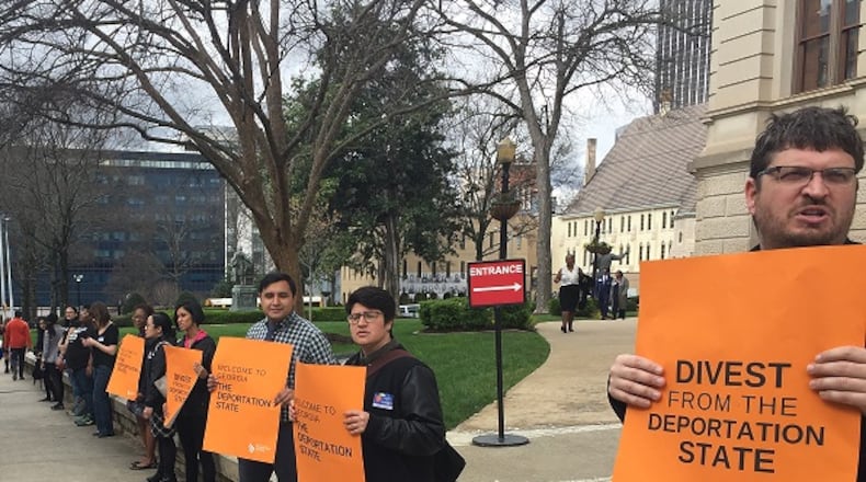 Activists protest Monday against Senate Bill 452 outside the Georgia Capitol, chanting “four-five-two, shame on you.” The bill would require local police and court officials in Georgia to help with immigration enforcement. Ariel Hart/ahart@ajc.com