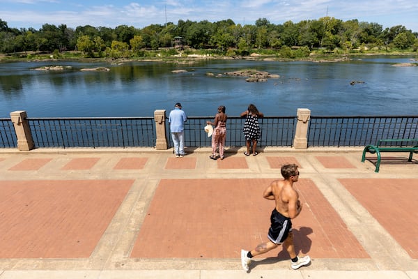 A person jogs along the Riverwalk in Columbus on Tuesday, Sept. 2, 2025. (Arvin Temkar/AJC)