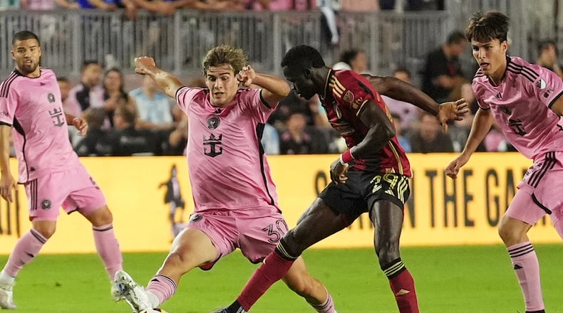 Inter Miami midfielder Benjamin Cremaschi (30) and Atlanta United forward Jamal Thiare (29) go after the ball during the first half of their MLS playoff opening round soccer match, Saturday, Nov. 9, 2024, in Fort Lauderdale, Fla. (AP Photo/Rebecca Blackwell)