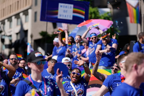 Participants around the World of Hyatt float march during the World Pride parade, Saturday, June 7, 2025, in Washington. (AP Photo/Mark Schiefelbein)