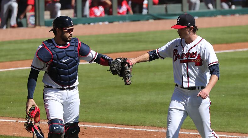 Braves pitcher Max Fried gets a glove bump from catcher Travis d’Arnaud during the sixth inning in Game 1 of the National League wild card playoff series on Wednesday, Sept. 30, 2020 in Atlanta. Curtis Compton / Curtis.Compton@ajc.com