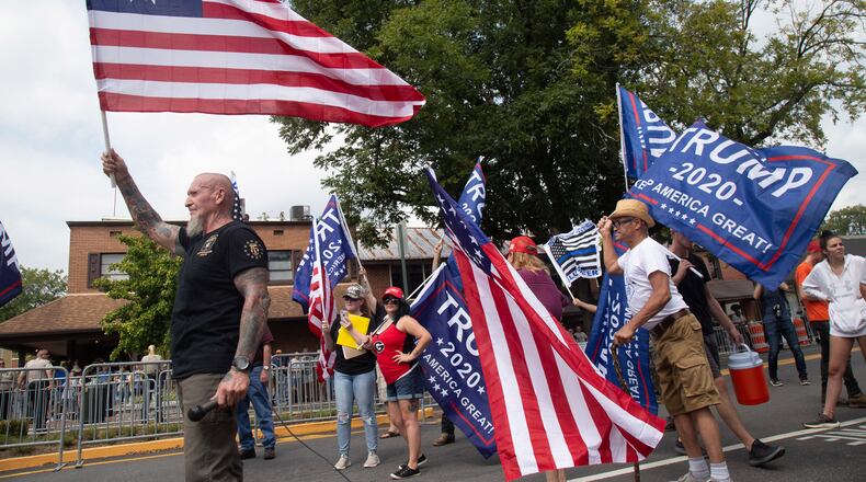 Chester Doles, the principal organizer of Saturdayâs pro-Trump rally in Dahlonega, waves a flag at the beginning of the rally September 14, 2019. STEVE SCHAEFER / SPECIAL TO THE AJC