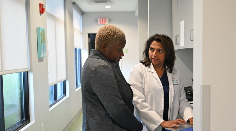 Dr. Anu Sheth (right) checks her daily schedule with Kelsey Harper-Neely, medical assistant, before the opening of the pediatric clinic at Pediatric Associates of Lawrenceville, Wednesday, August 9, 2023, in Lawrenceville. In June, 63,000 Georgia children lost Medicaid because the state did not receive the required application forms to keep them enrolled. Dr. Sheth's practice has already had parents show up for their child's appointment not knowing they were no longer insured because they needed to re-apply. (Hyosub Shin / Hyosub.Shin@ajc.com)
