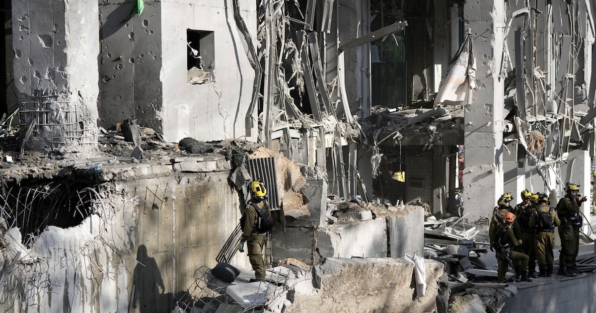 The Latest: Dozens wounded in Iranian strikes across Israel, as Israel hits Arak reactor site