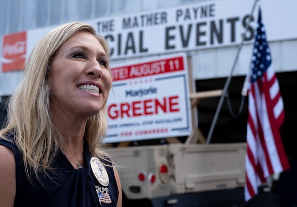 Then-candidate Marjorie Taylor Greene, running to represent Georgia's 14th congressional district, talks with supporters at a political rally at the Rome fairgrounds in August 2020. (Ben Gray for the AJC)