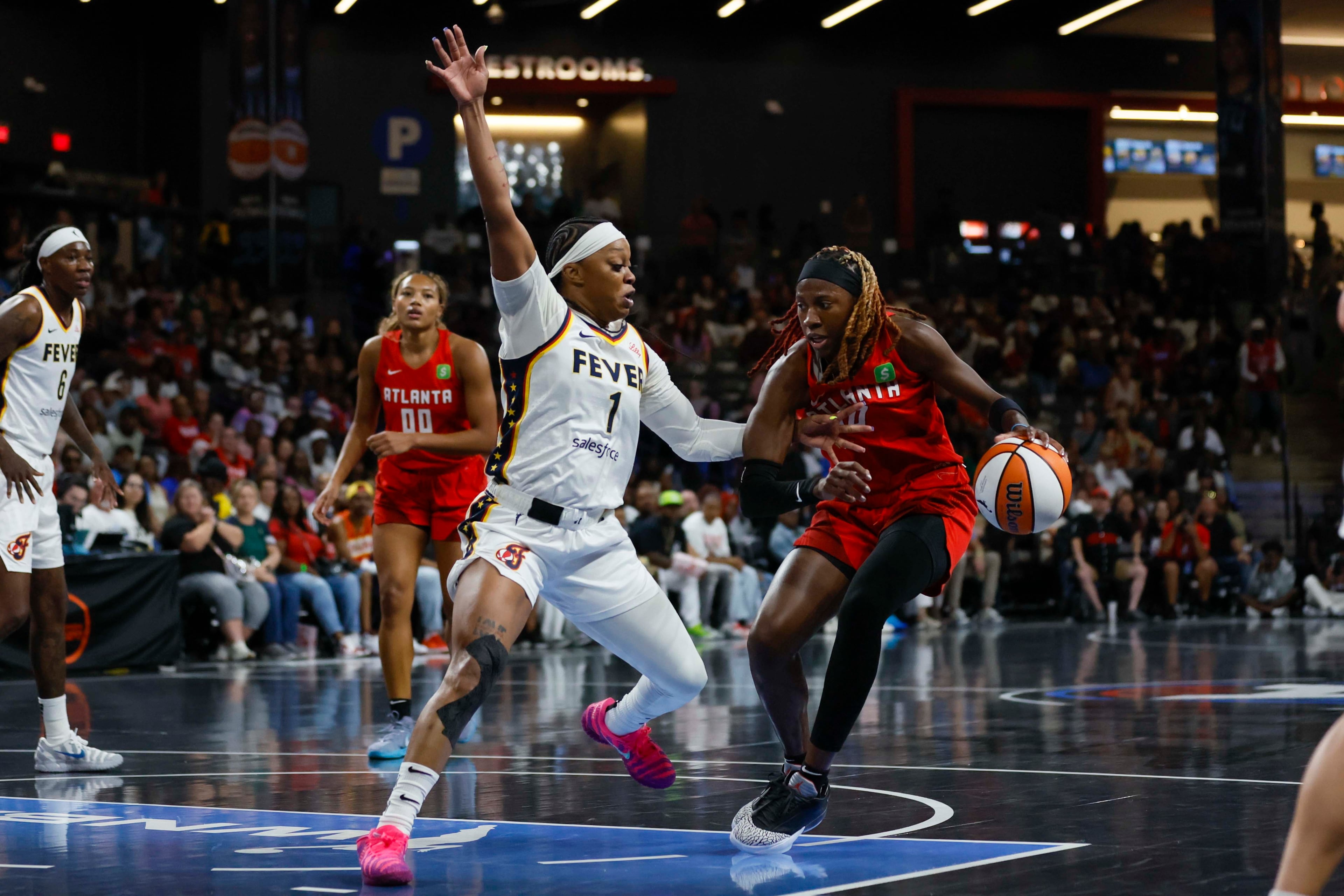 Atlanta Dream guard Rhyne Howard (10) dribbles against Indiana Fever guard Odyssey Sims (1) during the first half of a WNBA first-round playoff game at Gateway Center Arena on Thursday, Sept. 18, 2024, in Atlanta. (Miguel Martinez/ AJC)