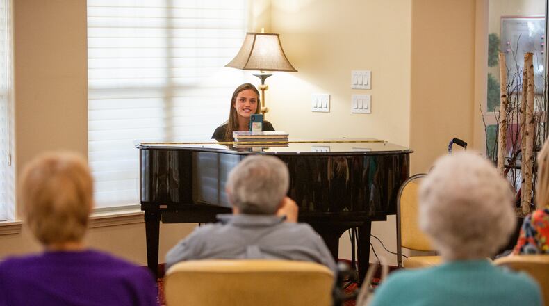 Kate Lauterbach sings and interacts with residents at Sanford Estates in Roswell. The 17-year-old Marist student has a passion for singing and is channeling it into a day-brightener for seniors. PHIL SKINNER FOR THE ATLANTA JOURNAL-CONSTITUTION.