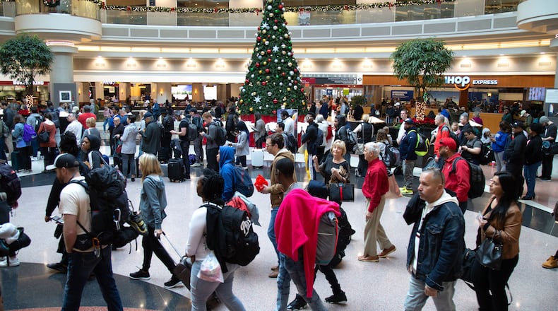 Travelers wait in long lines to get to the security checkpoint at Hartsfield-Jackson International Airport on Sunday on what is expected to set a record travel day for the U.S. airline industry on December 1, 2019.  (Photo: STEVE SCHAEFER / SPECIAL TO THE AJC)