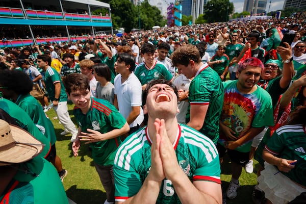 Mexico supporters watching a screen at the FIFA Fan Festival at Centennial Olympic Park in Atlanta celebrate after the team scored a goal in its game against South Africa on Thursday, June 11, 2026. (Miguel Martinez/AJC)