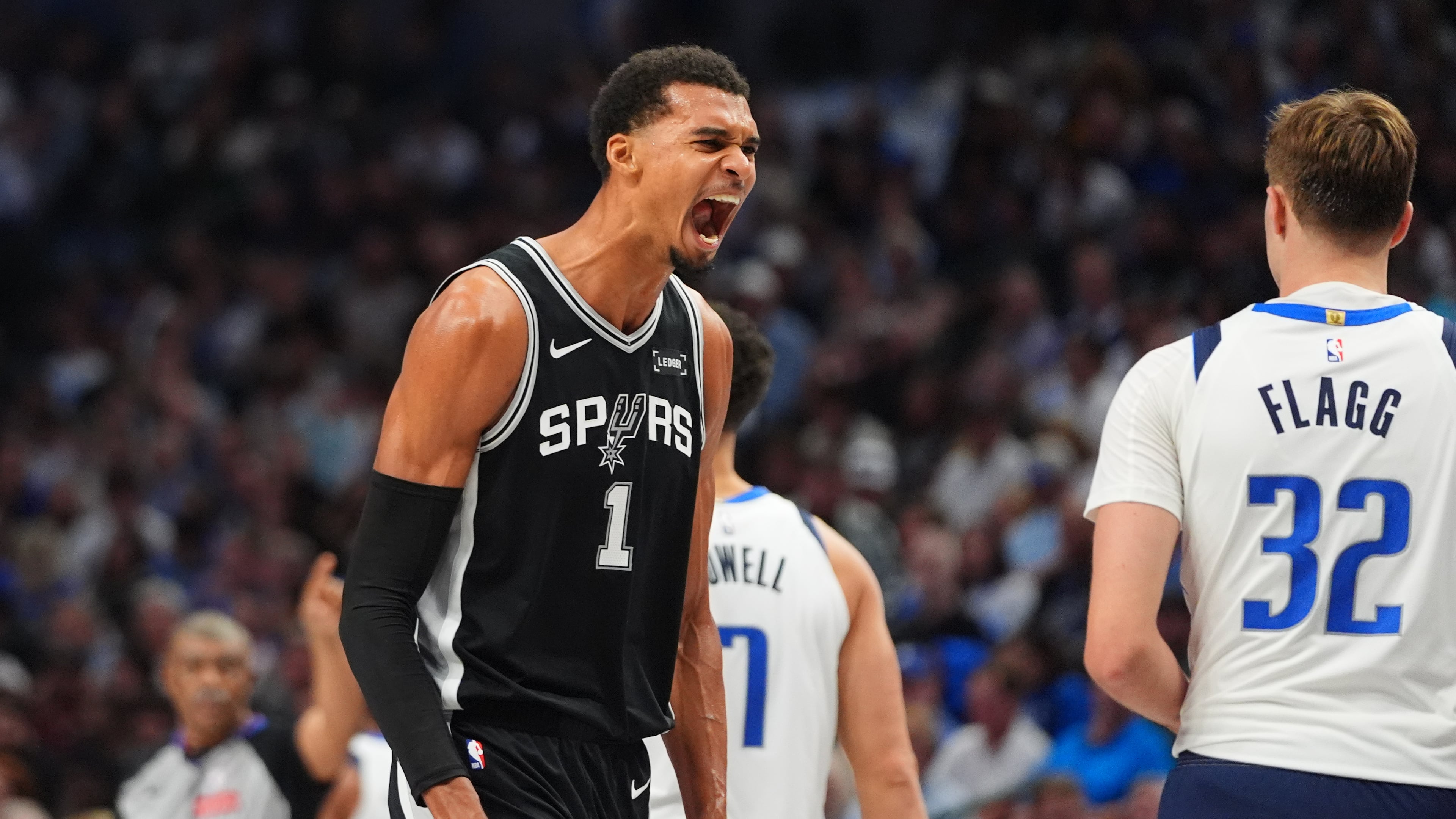 San Antonio Spurs forward Victor Wembanyama (1) reacts near Dallas Mavericks forward Cooper Flagg (32) during the first half of an NBA basketball game in Dallas, Wednesday, Oct. 22, 2025. (AP Photo/LM Otero)