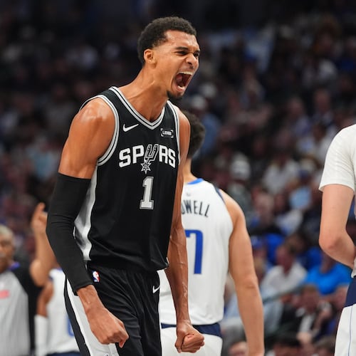 San Antonio Spurs forward Victor Wembanyama (1) reacts near Dallas Mavericks forward Cooper Flagg (32) during the first half of an NBA basketball game in Dallas, Wednesday, Oct. 22, 2025. (AP Photo/LM Otero)