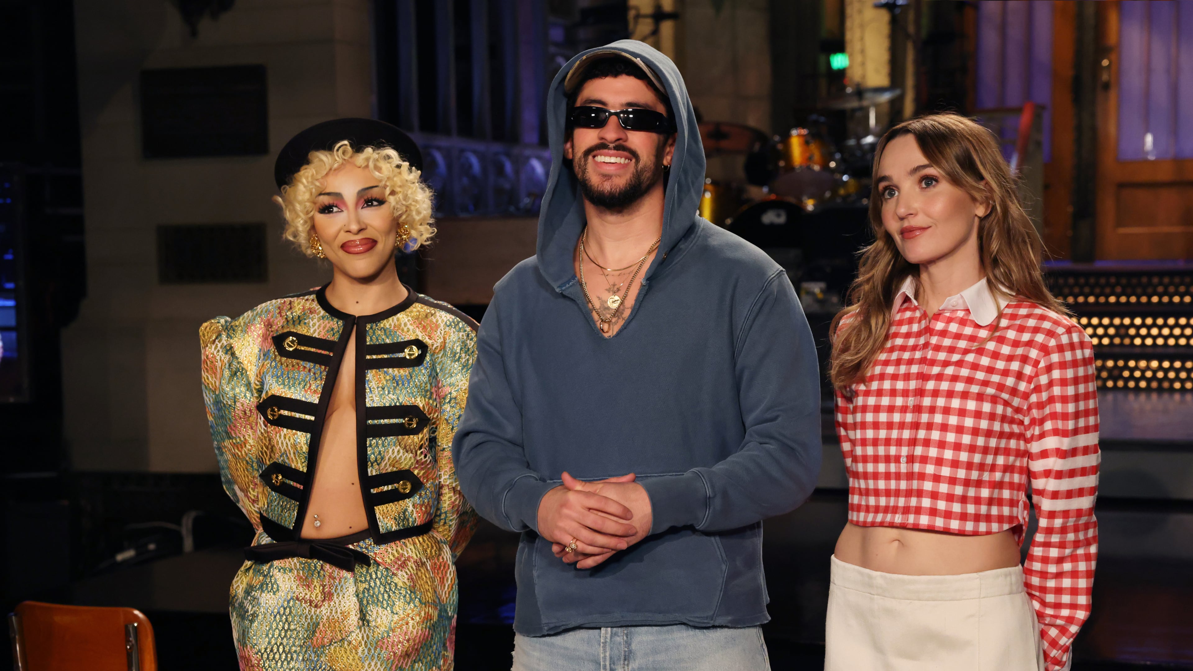This image released by NBC shows host Bad Bunny, center, with musical guest Doja Cat, left, and cast member Chloe Fineman during the taping of promotional spots for the upcoming "Saturday Night Live" on Thursday, Oct. 2, 2025. (Rosalind O'Connor/NBC via AP)