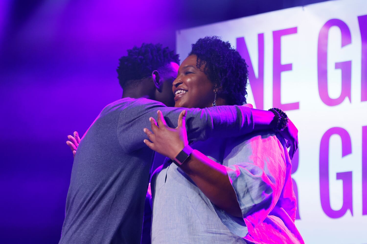 Therrell  High School valedictorian Daniel Hermonstine welcomes Stacey Abrams to the stage during the One Georgia Our Georgia Stacey Abrams campaign event. The vent was dedicated to young scholars to promote the vote at Terminal West on Monday, June 6, 2022. Miguel Martinez / miguel.martinezjimenez@ajc.com