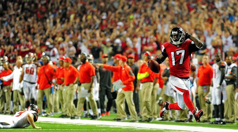 Devin Hester pays tribute to Deion Sanders as he avoids a tackle attempt by punter Michael Koenen on his way to returning a punt for a touchdown during a game Sept. 18, 2014, at the Georgia Dome in Atlanta.