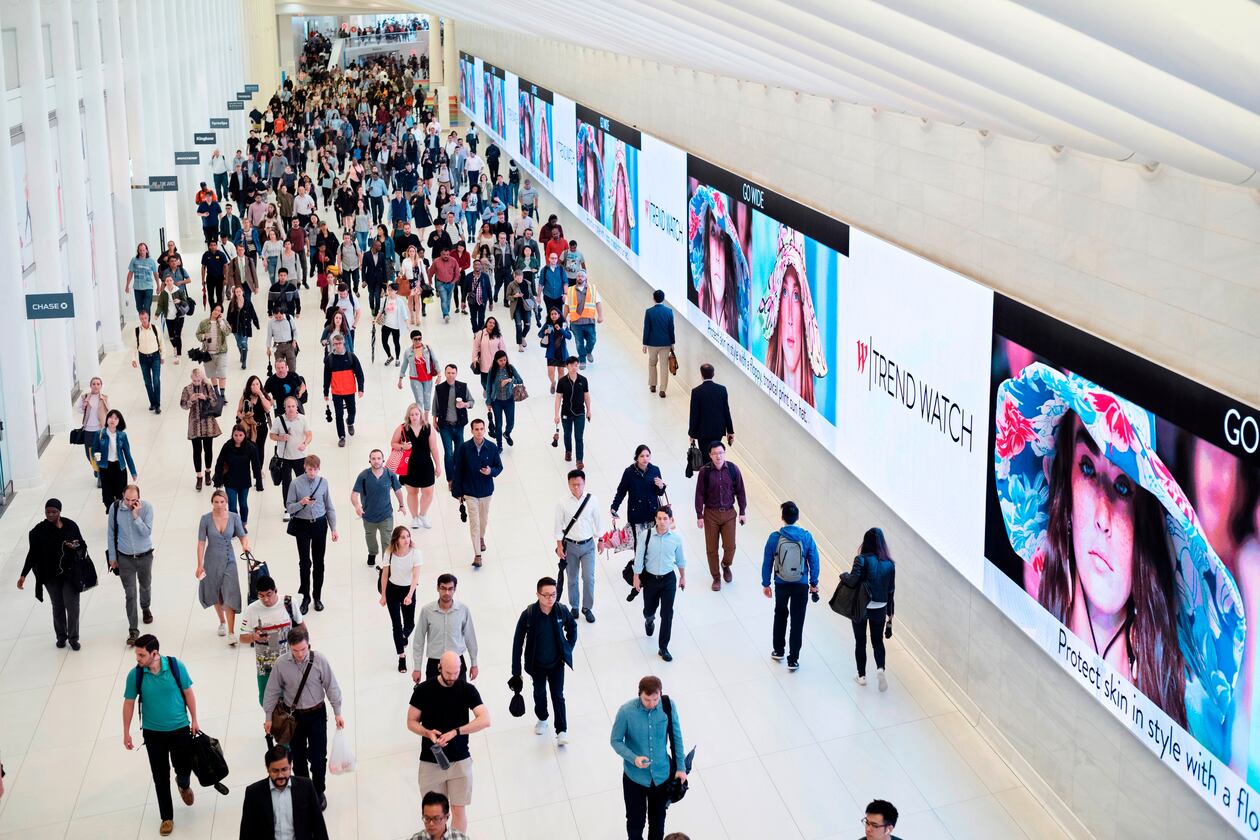 FILE - Commuters walk through a corridor in the World Trade Center Transportation Hub in New York on June 21, 2019. (AP Photo/Mark Lennihan, File)
