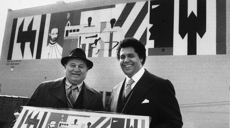 Mayor Maynard Jackson poses with artist Romare Bearden in front of a new mural by Bearden in downtown Atlanta. The mural, since demolished, was commissioned by the Urban Walls Project, in hand with the Arts Festival of Atlanta and Central Atlanta Progress. Jackson made the promotion of arts and culture a key part of his administration's legacy. (Billy Downs/AJC 1976 photo)