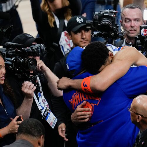 New York Knicks center Karl-Anthony Towns hugs his dad, Karl-Anthony Towns Sr., after Game 2 of the NBA Finals basketball series against the San Antonio Spurs, Friday, June 5, 2026, in San Antonio. (AP Photo/David J. Phillip)