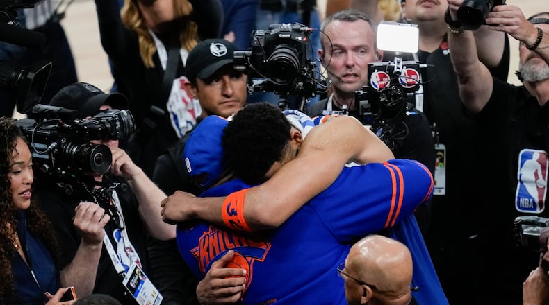 New York Knicks center Karl-Anthony Towns hugs his dad, Karl-Anthony Towns Sr., after Game 2 of the NBA Finals basketball series against the San Antonio Spurs, Friday, June 5, 2026, in San Antonio. (AP Photo/David J. Phillip)