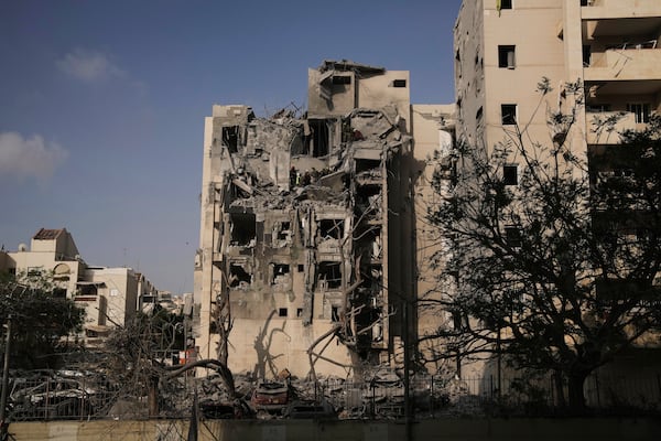 Israeli soldiers and a rescue team search for survivors amid the rubble of residential buildings destroyed by an Iranian missile strike that killed several people, in Beersheba, Israel, on Tuesday, June 24, 2025. (AP Photo/Leo Correa)