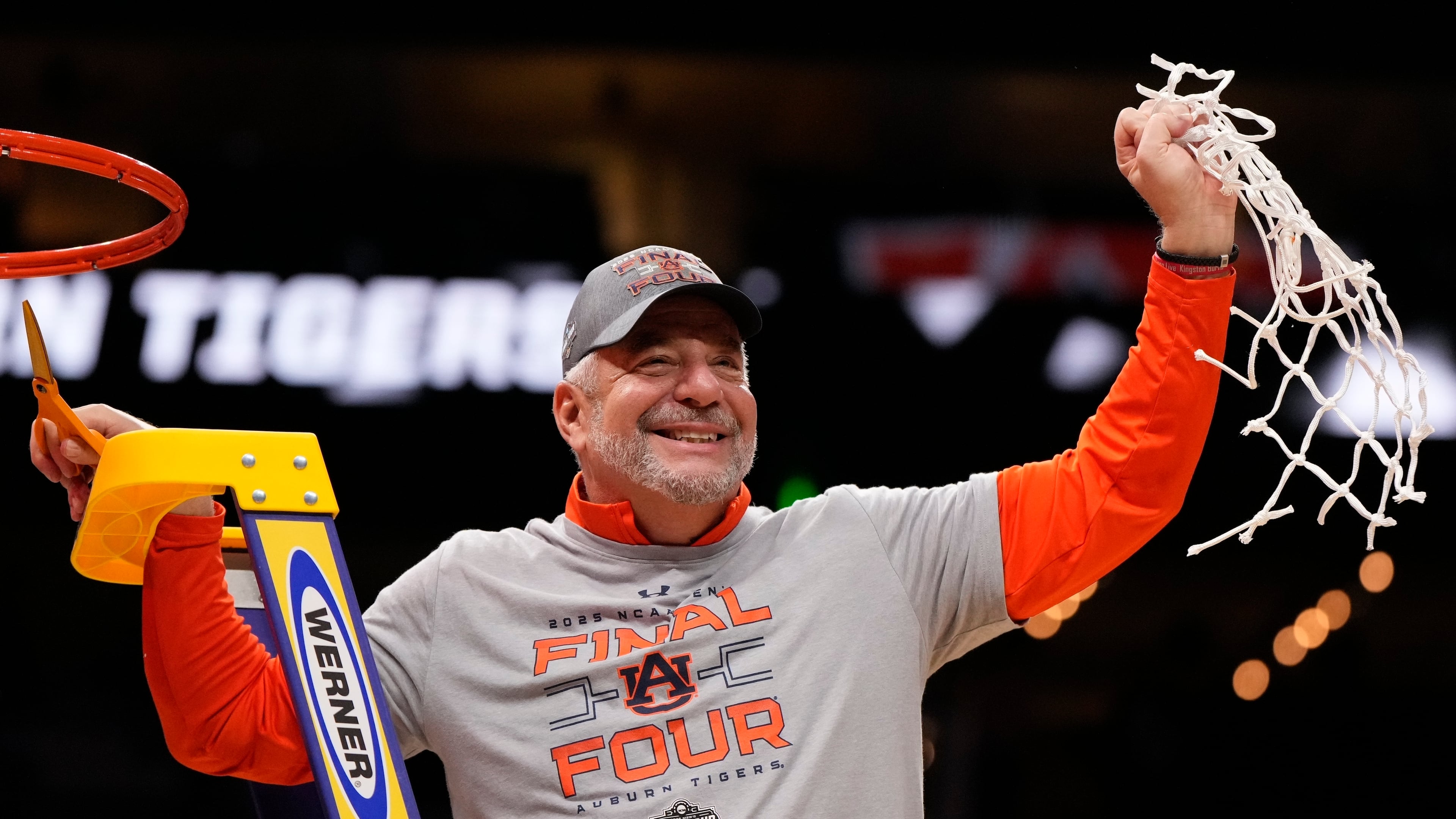 FILE - Auburn head coach Bruce Pearl celebrates with a net after the Elite Eight of the NCAA college basketball tournament against Michigan State, Sunday, March 30, 2025, in Atlanta. (AP Photo/Brynn Anderson, File)