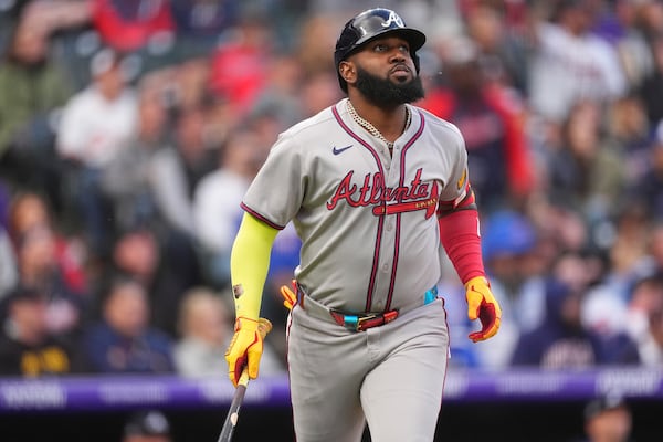 Atlanta Braves' Marcell Ozuna follows the flight of his sacrifice fly to drive in a run off Colorado Rockies starting pitcher Ryan Feltner in the third inning of a baseball game Monday, April 28, 2025, in Denver. (AP Photo/David Zalubowski)