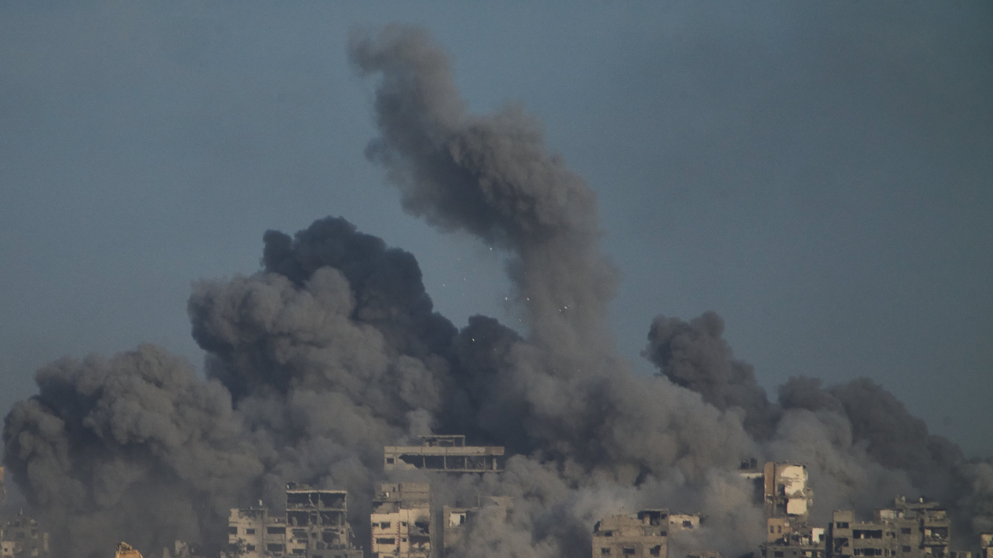 Smoke billows over Gaza Strip following an Israeli bombardment, as seen from southern Israel, Sunday, Oct. 5, 2025. (AP Photo/Ariel Schalit)