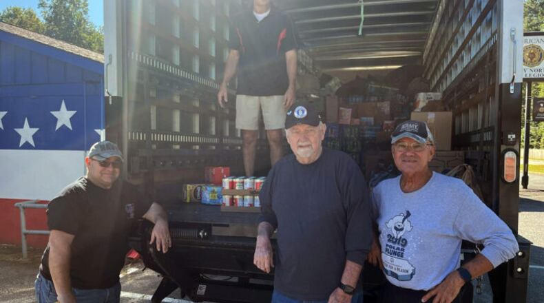 From left, Dan Harr; Jess, on the truck; Howard Kanour; and Ron Asby American Post 304 Commander Chuck Guta loading the truck.