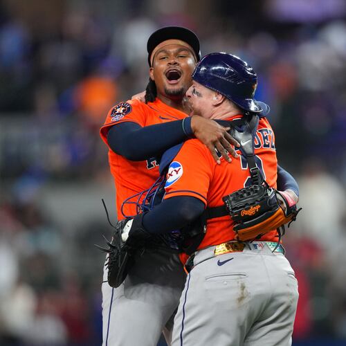 Houston Astros pitcher Alimber Santa, left, reacts with catcher Christian Vázquez after completing their team's combine no-hitter win over the Texas Rangers during a baseball game Monday, May 25, 2026, in Arlington, Texas. (AP Photo/Julio Cortez)