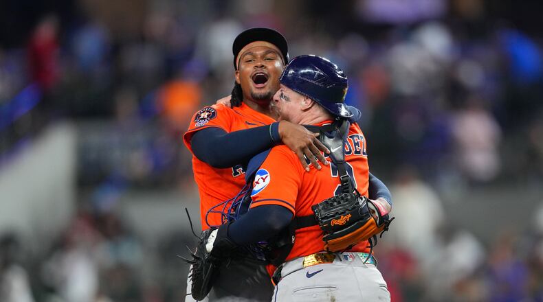 Houston Astros pitcher Alimber Santa, left, reacts with catcher Christian Vázquez after completing their team's combine no-hitter win over the Texas Rangers during a baseball game Monday, May 25, 2026, in Arlington, Texas. (AP Photo/Julio Cortez)