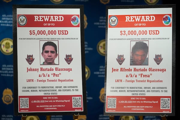 Images of Johnny Hurtado Olascoaga and Jose Alfredo Hurtado Olascoaga, who are accused of participating in a conspiracy to manufacture cocaine, heroin, methamphetamine and fentanyl and conspiracy to import and distribute the drugs in the United States, are displayed during a news conference Tuesday, April 15, 2025, in Atlanta. (AP Photo/Brynn Anderson)