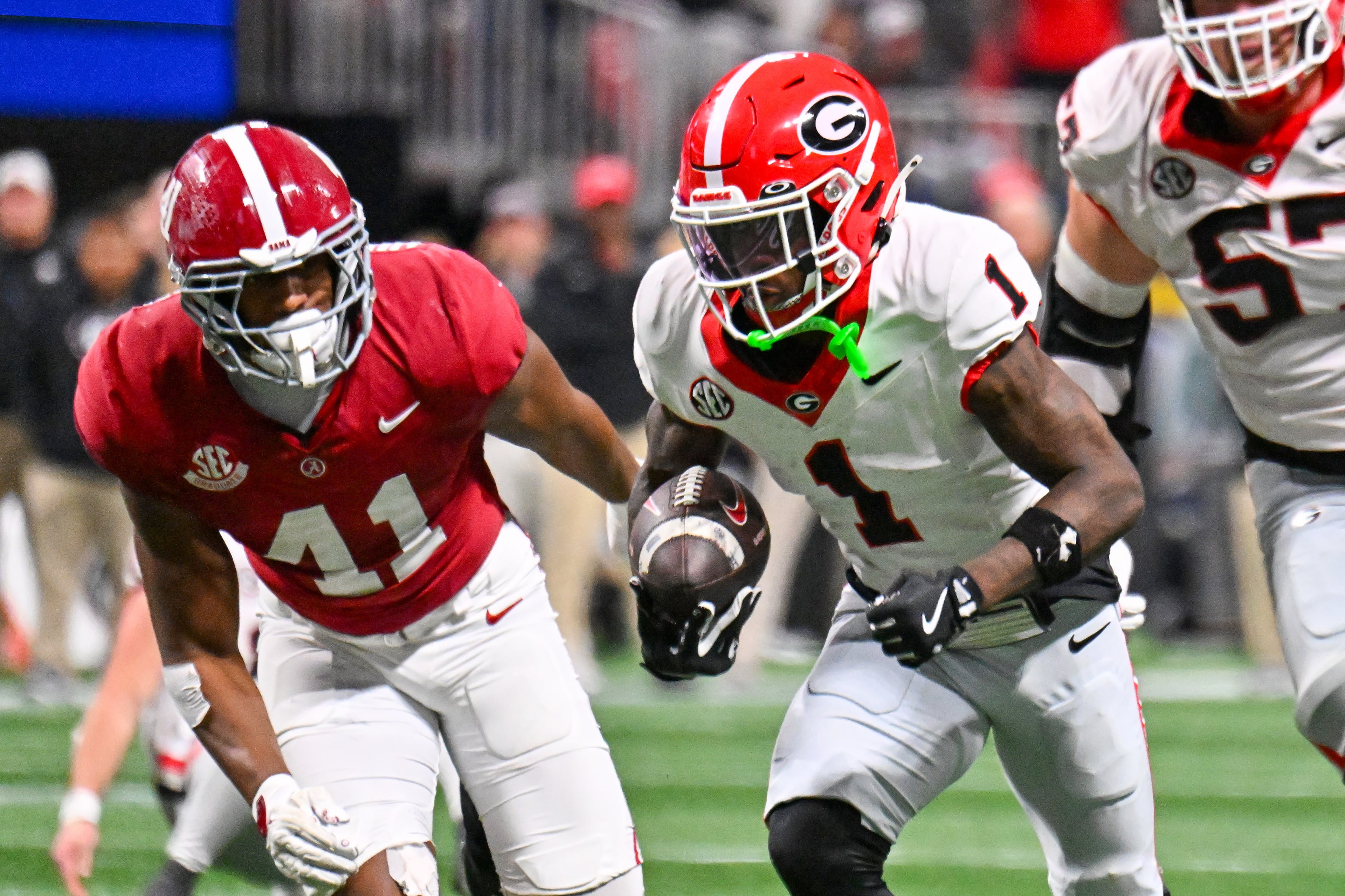 Georgia wide receiver Zachariah Branch (1) runs for a 13-yard touchdown against Alabama defensive lineman Jordan Renaud (11) during the fourth quarter of the SEC Championship game at Mercedes-Benz Stadium, Saturday, Dec. 6, 2025, in Atlanta. (Hyosub Shin / AJC)