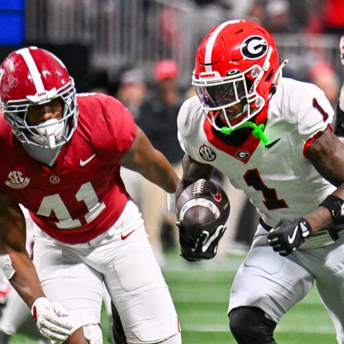 Georgia wide receiver Zachariah Branch (1) runs for a 13-yard touchdown against Alabama defensive lineman Jordan Renaud (11) during the fourth quarter of the SEC Championship game at Mercedes-Benz Stadium, Saturday, Dec. 6, 2025, in Atlanta. (Hyosub Shin / AJC)
