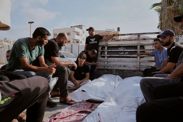 Mourners attend the funeral of their relatives who were killed in an Israeli bombardment, in Deir al-Balah, Gaza Strip, Saturday, July 12, 2025. (AP Photo/Abdel Kareem Hana)