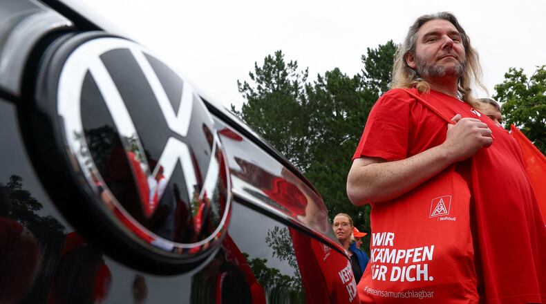Employees of carmaker Volkswagen AG and IG Metall union members rally on the grounds of the Volkswagen headquarters on the day of the supervisory board meeting, in Wolfsburg, Germany, Thursday, July 9, 2026. (Lisi Niesner/Pool Photo via AP)