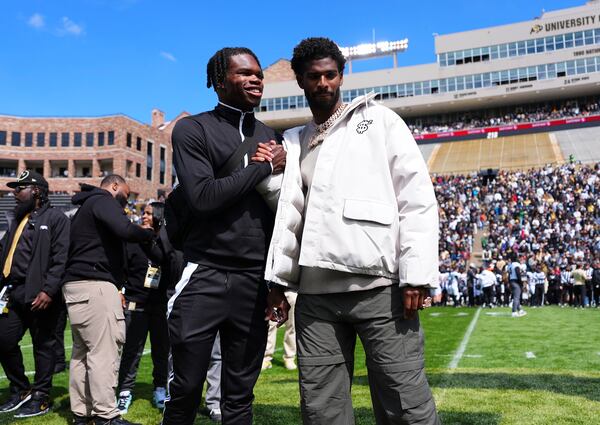 Travis Hunter and Shedeur Sanders react to their jersey retirements during the Colorado spring game, Saturday, April 19, 2025, in Boulder, Colo. (AP PhotoJack Dempsey)