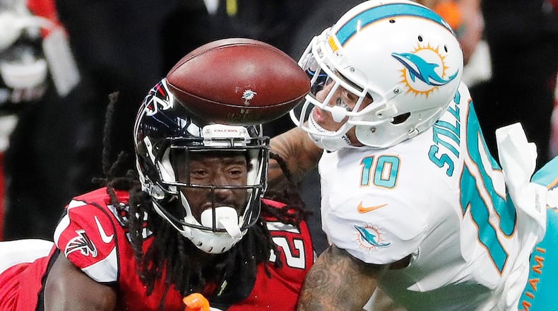 Atlanta Falcons cornerback Desmond Trufant (21) breaks up the catch against Miami Dolphins wide receiver Kenny Stills (10) during the first half of an NFL football game, Sunday, Oct. 15, 2017, in Atlanta. (AP Photo/David Goldman)