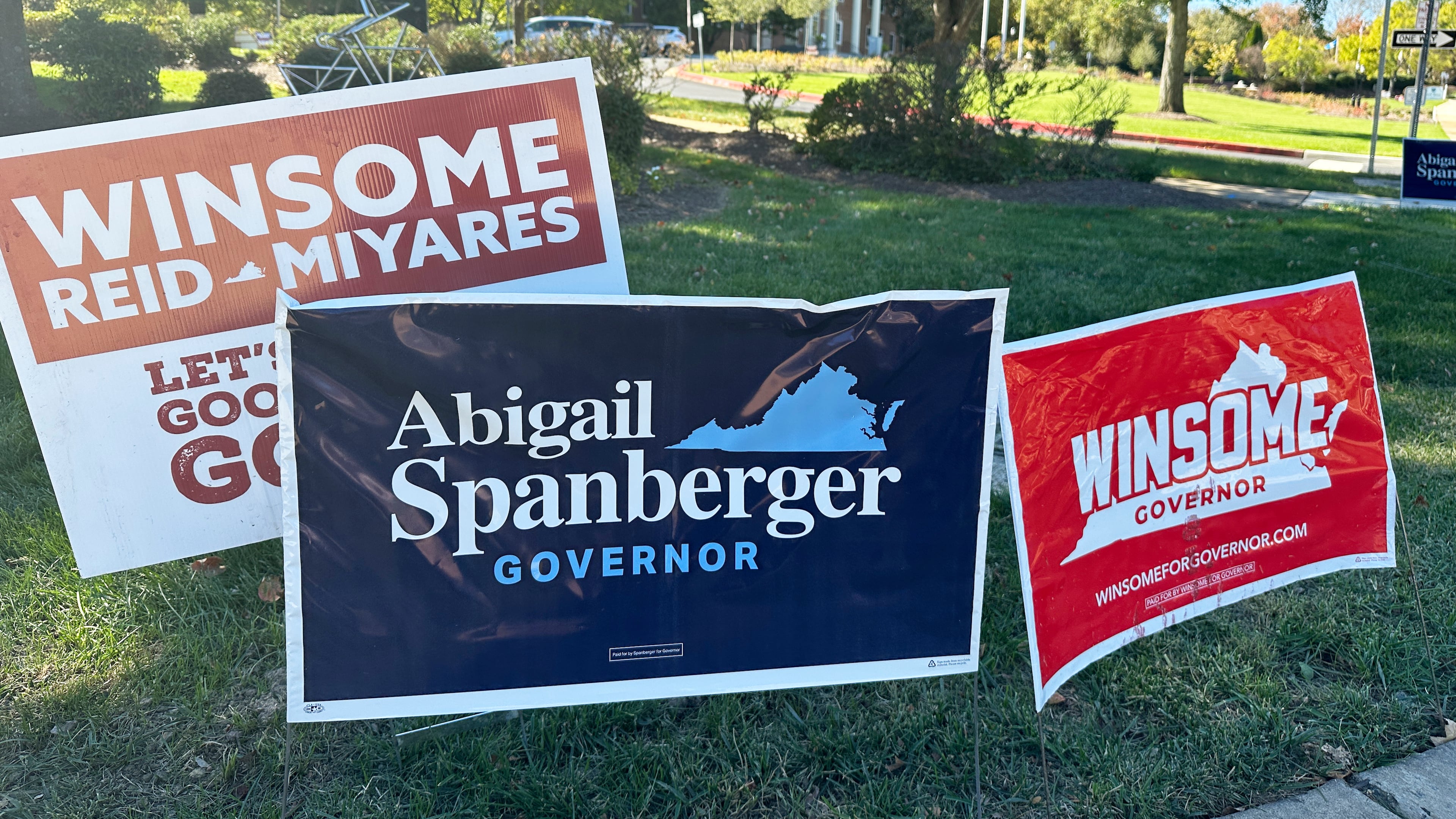 Campaign signs for Virginia gubernatorial nominees Democrat Abigail Spanberger and Republican Winsome Earle-Sears are on display outside City Hall in Fairfax, Va., Friday, Oct. 17, 2025. (AP Photo/Robert Yoon)