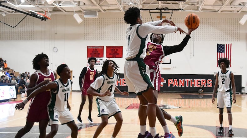 Holy Innocents Episcopal Jaden McCullough (right) shoots against KIPP Atlanta Collegiate Akil Robinson during Region 5AA Championship game at Therrell High School, Thursday, Feb. 19, 2026, in Atlanta. Holy Innocents Episcopal won 56-46 over KIPP Atlanta Collegiate. (Hyosub Shin/AJC)